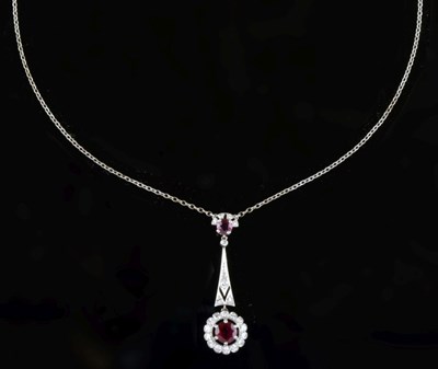Lot 58 - Diamond and ruby cluster drop pendant