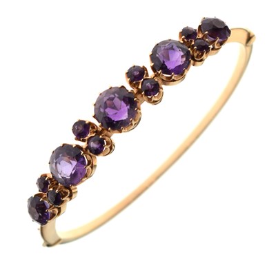 Lot 198 - Amethyst set yellow metal snap bangle
