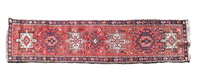 Lot 736 - Persian runner rug on a red ground, 268cm x 71cm