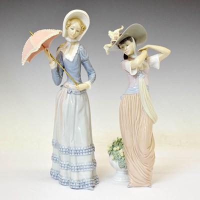 Lot 661 - Lladro - Two porcelain figures - 'Paris in Bloom' 6280, and lady holding parasol