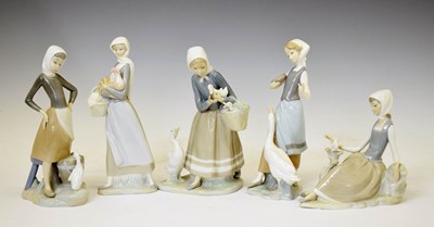 Lot 662 - Lladro - Five porcelain figures - 'Girl With Duck' 1052, lady with ducks, maid with hen, etc