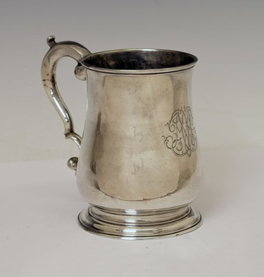 Lot 132 - George II silver mug of baluster form with scroll handle