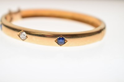 Lot 56 - Victorian diamond and sapphire unmarked yellow metal hinged bangle