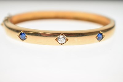 Lot 56 - Victorian diamond and sapphire unmarked yellow metal hinged bangle