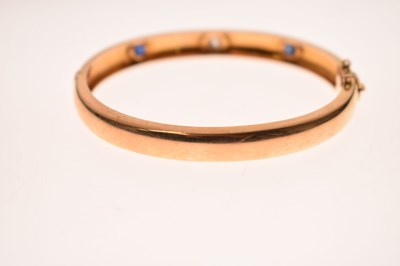 Lot 56 - Victorian diamond and sapphire unmarked yellow metal hinged bangle