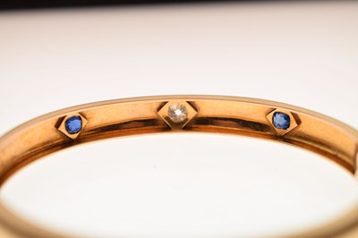 Lot 56 - Victorian diamond and sapphire unmarked yellow metal hinged bangle