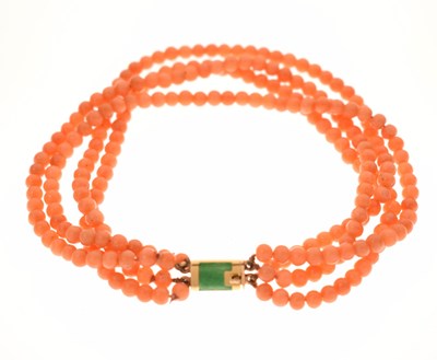 Lot 180 - Coral four-strand bracelet with French gold and green enamel clasp