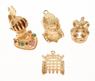 Lot 241 - Four 9ct gold charms - Armour x 2, Crown, Portcullis