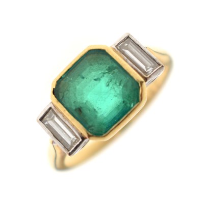 Lot 23 - Emerald and diamond 18ct yellow gold and white gold set three stone ring