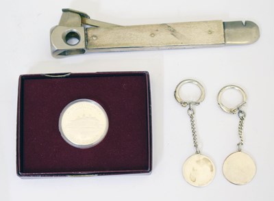 Lot 257 - Elizabeth II silver-mounted cigar cutter, key ring, and American silver half dollar
