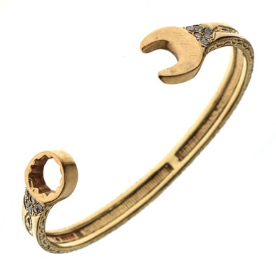 Lot 127 - 9ct gold diamond set 'spanner' bangle