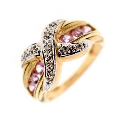 Lot 27 - Pink sapphire and diamond crossover 9ct gold dress ring