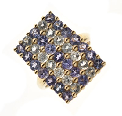 Lot 36 - Tanzanite and white stone five-row 9ct gold panel ring