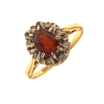 Lot 50 - Garnet and diamond 18ct gold cluster ring