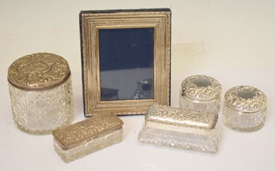 Lot 254 - Elizabeth II silver mounted easel photo frame, and five silver topped dressing table jars