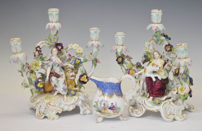 Lot 638 - Pair of Dresden porcelain floral encrusted three-branch figural candlesticks