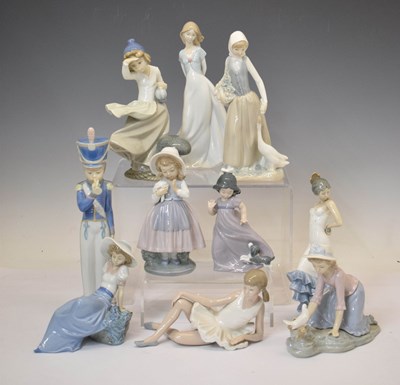 Lot 639 - Lladro figure - Cadet with bugle, and eight Nao figurines