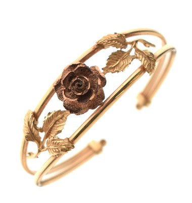 Lot 132 - 9ct gold torque bangle, with rose and leaf decoration