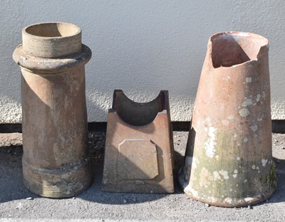 Lot 564 - Two terracotta rhubarb forcers / chimney crowns and a stand