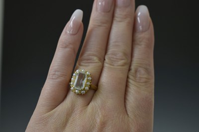 Lot 22 - Aquamarine and seed pearl unmarked yellow metal ring