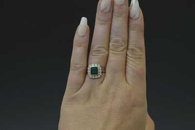 Lot 21 - Emerald and diamond 18ct yellow and white gold set cluster ring
