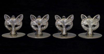 Lot 72 - Cased set of four George V silver novelty menu card holders in the form of four fox masks