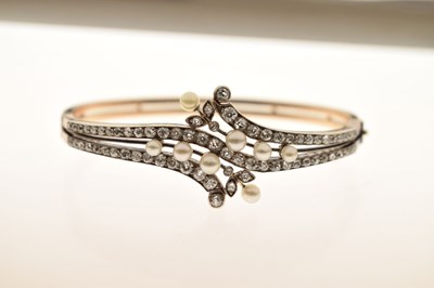 Lot 34 - Late 19th / early 20th century diamond and pearl hinged bangle