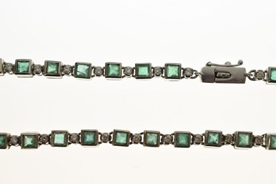Lot 35 - Emerald and diamond 18ct white gold 'tennis' style necklace