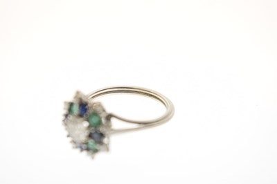 Lot 17 - Diamond, sapphire and emerald unmarked white metal cluster ring
