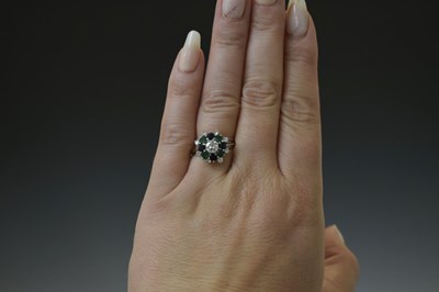 Lot 17 - Diamond, sapphire and emerald unmarked white metal cluster ring