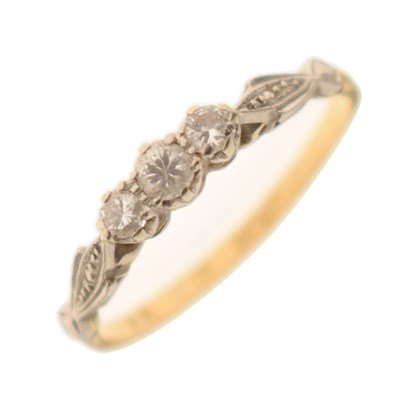 Lot 66 - Diamond three-stone yellow metal ring