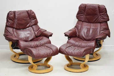 Lot 715 - Near pair of Stressless reclining chairs with footstools