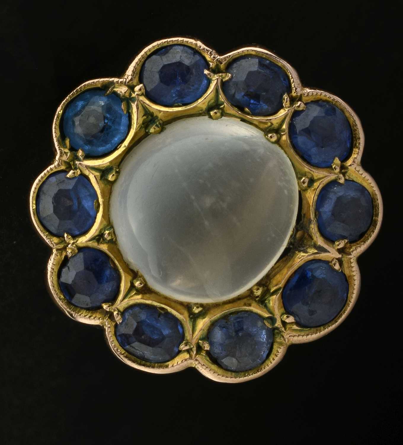 Lot 23 - Moonstone and sapphire 9ct gold cluster ring