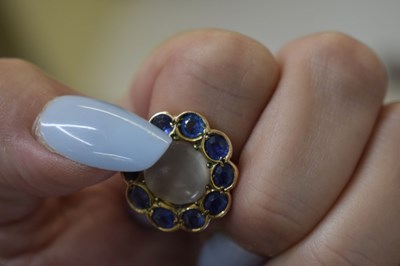 Lot 23 - Moonstone and sapphire 9ct gold cluster ring
