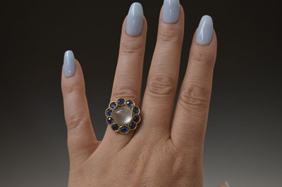 Lot 23 - Moonstone and sapphire 9ct gold cluster ring