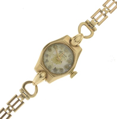 Lot 244 - Accurist - 1950s lady's 9ct gold cased bracelet watch, on a yellow metal bracelet