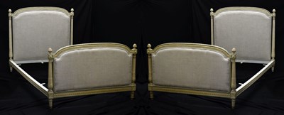 Lot 451 - Pair of French Louis XVI style carved and painted wooden and upholstered bedsteads