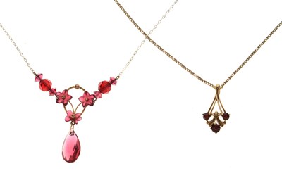 Lot 144 - 9ct gold garnet three-stone set pendant, and a red stone and yellow metal pendant necklace