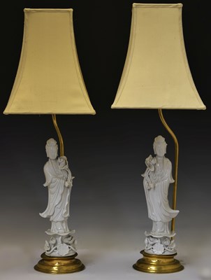 Lot 220 - Mirror pair of Chinese Dehua blanc de chine porcelain figures of Guanyin (now as table lamps)