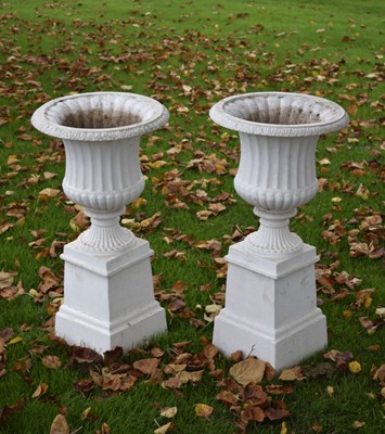 Lot 534 - Pair of Victorian-style white painted cast aluminium pedestal urns
