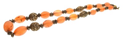 Lot 162 - Chinese peach agate bead and filigree metal necklace