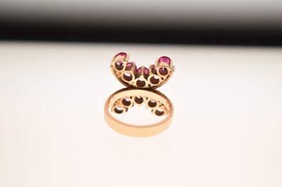 Lot 23 - 9ct gold ring set ten rubies in double 'C' formation