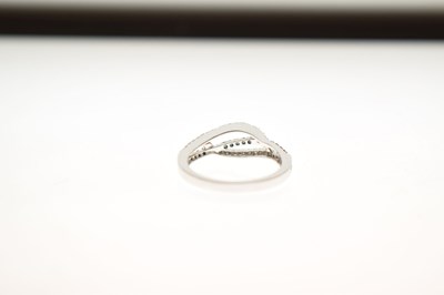 Lot 8 - White and blue diamond 9ct white gold half eternity ring