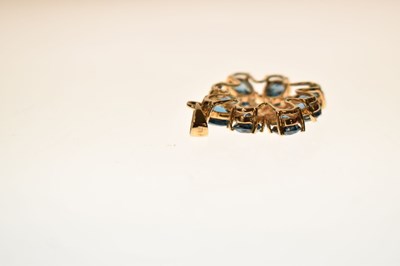 Lot 90 - 'London' blue topaz and diamond starburst 9ct gold pendant