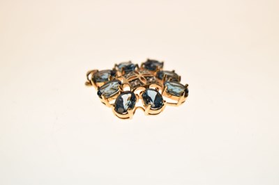 Lot 90 - 'London' blue topaz and diamond starburst 9ct gold pendant