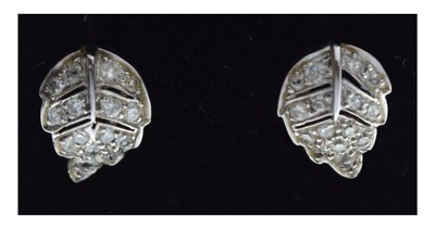Lot 65 - Pair of unmarked white metal leaf design diamond set stud earrings