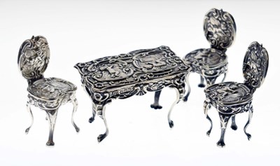 Lot 147 - Edward VII silver miniature table and a pair of chairs, and one Elizabeth II silver chair