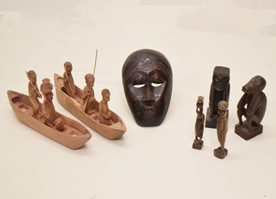 Lot 264 - Collection of African carved hardwood figures, mask, canoe withn figures, etc