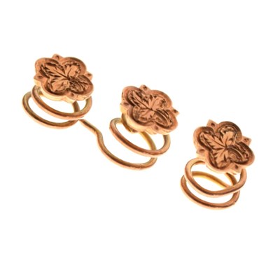 Lot 94 - Three small rose gold flower design studs