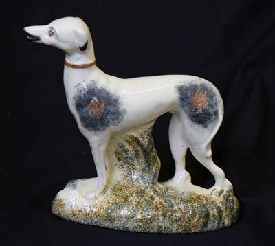 Lot 479 - Pottery figure of a greyhound